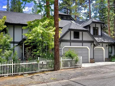 a white fence in front of a house at No. 8 Estate By The Lake in Big Bear Lake