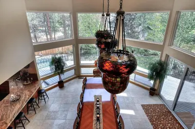 a large room with windows and a hanging basket at No. 8 Estate By The Lake in Big Bear Lake