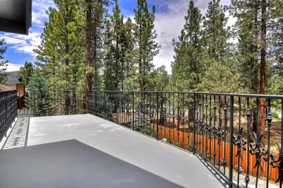 a balcony with a basketball court with trees at No. 8 Estate By The Lake in Big Bear Lake
