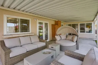 a living room with two couches on a porch at Huntington Beach Home Fire Pit, Grill and More! in Huntington Beach