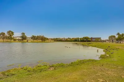 a lake with ducks swimming in the water at Huntington Beach Home Fire Pit, Grill and More! in Huntington Beach