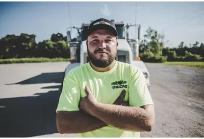 a man is standing in front of a truck at Studio 6 Suites Santa Ana, CA in Santa Ana