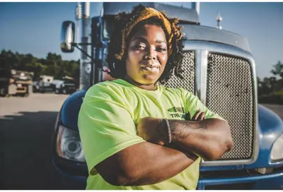 a young woman standing in front of a truck at Studio 6 Suites Santa Ana, CA in Santa Ana