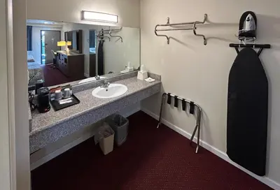 a bathroom with a sink and a mirror at Studio 6 Suites Santa Ana, CA in Santa Ana
