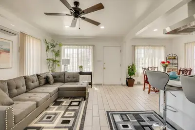a living room with a couch and a table at 2 Mi to SoFi Stadium Updated Inglewood Home! in Los Angeles