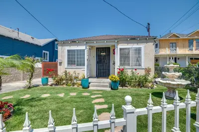 a white fence in front of a house at 2 Mi to SoFi Stadium Updated Inglewood Home! in Los Angeles
