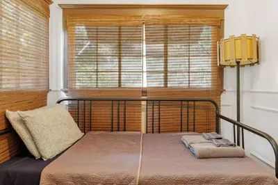 a bedroom with a bed in front of a window at Hollywood Hills Walk to Universal City Views in Los Angeles
