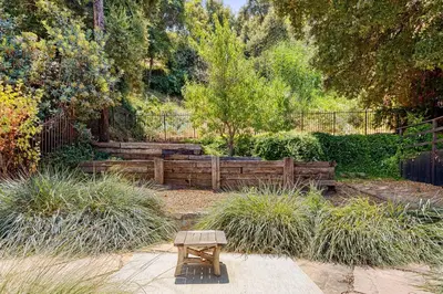 a wooden bench in the middle of a garden at Hollywood Hills Walk to Universal City Views in Los Angeles