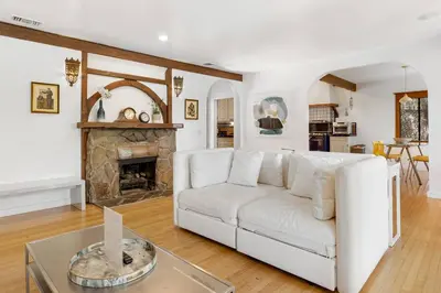 a living room with a white couch and a fireplace at Hollywood Hills Walk to Universal City Views in Los Angeles