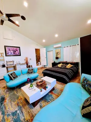 a large living room with blue furniture and a couch at Luxury Guesthouse in Los Angeles