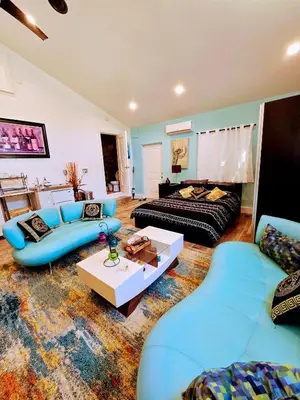a living room with blue couches and a table at Luxury Guesthouse in Los Angeles