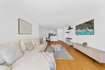 a white living room with a couch and a table at The Orchid-Beachfront Bliss Spacious 2BR Apt In Santa Monica in Los Angeles