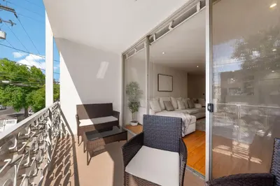a room with a balcony with a bed and a couch at The Orchid-Beachfront Bliss Spacious 2BR Apt In Santa Monica in Los Angeles