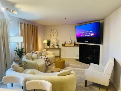 a living room with a flat screen tv on a wall at Mid-City Charm 2BR Near LAs Hotspots! in Los Angeles