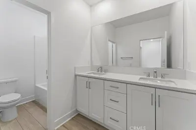 a white bathroom with a toilet and a sink at Luxury 4 bedroom house Los Angeles in Castaic Junction