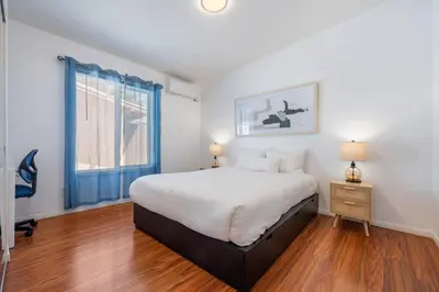 a bedroom with a large bed and a window at Woodland Victory Hideaway in Tarzana