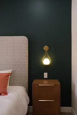 a bedroom with a bed and a lamp on a nightstand at Adobe Inn in Monterey Park
