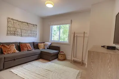 a living room with a couch and a window at Walk to Venice Beach from Luxury home in Los Angeles