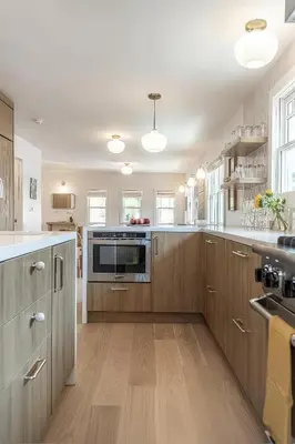 a large kitchen with wooden cabinets and a microwave at Walk to Venice Beach from Luxury home in Los Angeles