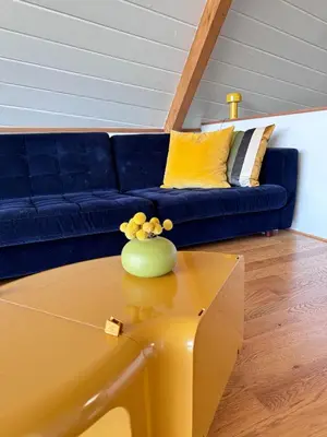 a living room with a blue couch and a table at Architectural Marvel in Hollywood Hills with Views in Los Angeles