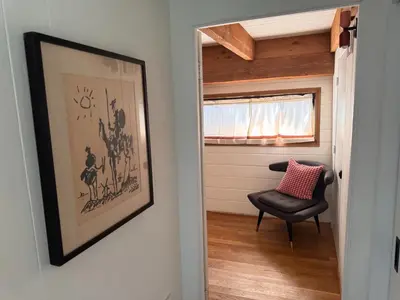 a room with a chair and a picture on the wall at Architectural Marvel in Hollywood Hills with Views in Los Angeles