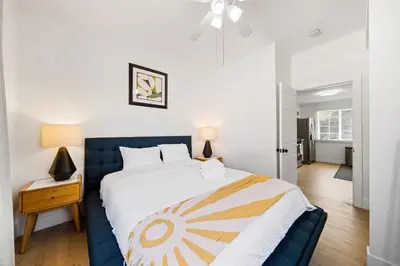 a bedroom with a large bed with a blue headboard at 2Bedroom home for your comfort and relaxation in Alhambra
