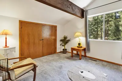 a living room with a large window and a wooden door at Four little bears cabin #2490 in Big Bear Lake