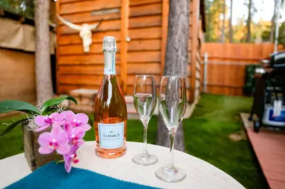 a bottle of wine and two wine glasses on a table at The nest on towne trail #2480 in Big Bear Lake