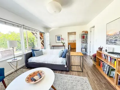 a living room with a couch and a table at Serene and beautiful hillside retreat in Glendale