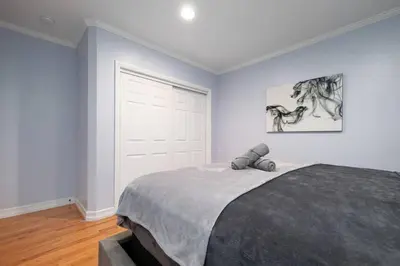 a bedroom with a bed and a white door at Elegance Escape Sleeps 10 Pool with Jacuzzi in Los Angeles