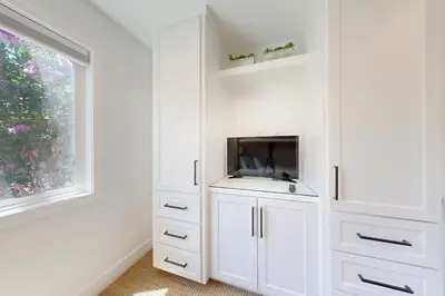 a white cabinet with a tv and a window at Mickey's Hideaway in Anaheim