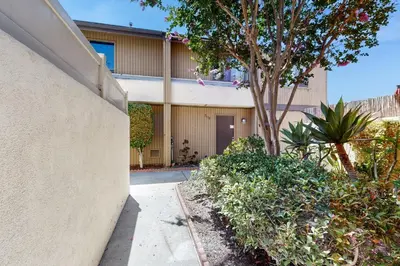 an apartment building with a sidewalk in front of it at Mickey's Hideaway in Anaheim