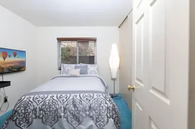 a white bedroom with a bed and a window at The Best View in The City! in Castaic