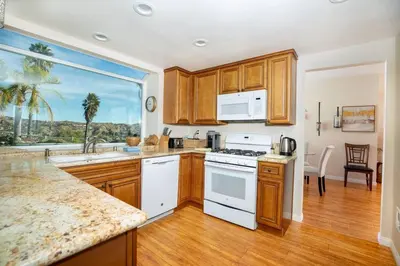 a kitchen with white appliances and a large window at The Best View in The City! in Castaic
