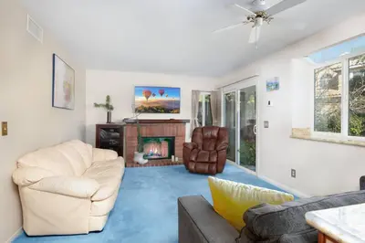 a living room with white furniture and a fireplace at The Best View in The City! in Castaic
