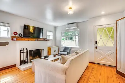 a living room with a couch and a fireplace at Less Than 1 Mi to Venice Beach and Boardwalk! Quiet Cottage in Los Angeles