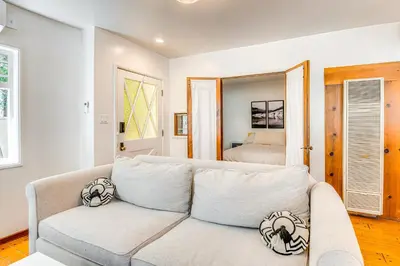 a living room with a couch and a bed at Less Than 1 Mi to Venice Beach and Boardwalk! Quiet Cottage in Los Angeles