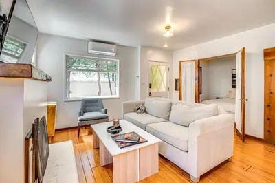 a living room with a couch and a table at Less Than 1 Mi to Venice Beach and Boardwalk! Quiet Cottage in Los Angeles