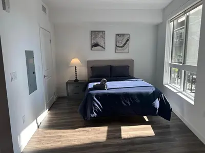 a bedroom with a bed with a teddy bear on it at Awesome Loft at Hollywood FREE Parking in Los Angeles