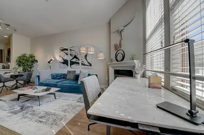 a living room with a blue couch and a table at Penthouse One Bedroom Garden View Condo by UCLA in Los Angeles