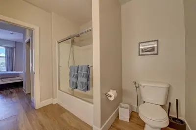 a bathroom with a toilet and a walk in shower at Penthouse One Bedroom Garden View Condo by UCLA in Los Angeles