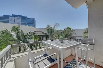 a balcony with a table and chairs on a balcony at Penthouse One Bedroom Garden View Condo by UCLA in Los Angeles