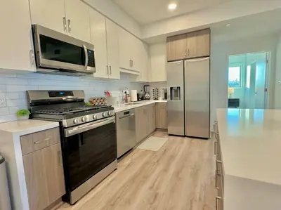 a kitchen with a stove and a refrigerator at Corner 2 Bedroom 2 Bath Condo - Balcony - Parking in Los Angeles
