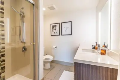 a bathroom with a toilet and a sink and a shower at Trendy 2BD 2BTH Apt steps from Downtown Santa Monica! in Los Angeles