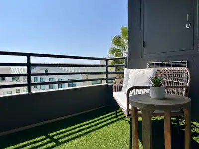 a balcony with a chair and a table on a balcony at Stunning 2BD 2BTH Apt in Santa Monica! in Los Angeles