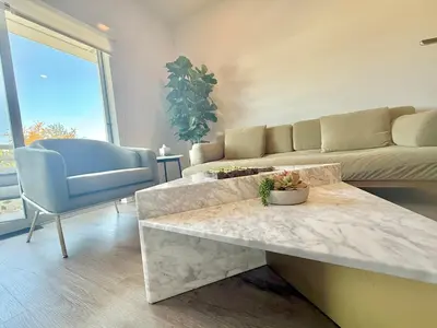 a living room with a couch and a table at Designer Silver Lake Stylish One Bedroom with Parking in Los Angeles