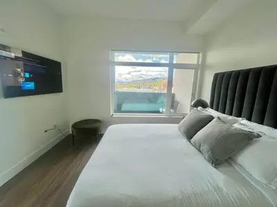 a bedroom with a large bed and a window at Luxe Corner One Bedroom, Prime Hollywood with Parking in Los Angeles