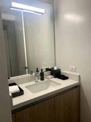 a bathroom with a sink and a large mirror at Luxe Corner One Bedroom, Prime Hollywood with Parking in Los Angeles