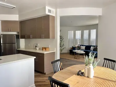 a kitchen and living room with a table and a dining room at Big 3BD 2BA Apt with Pool and Gym near Venice Beach in Los Angeles