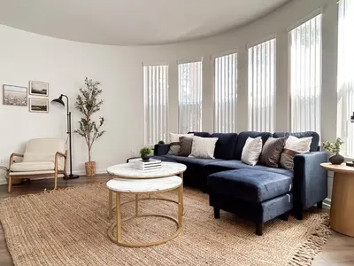 a living room with a blue couch and a table at Big 3BD 2BA Apt with Pool and Gym near Venice Beach in Los Angeles